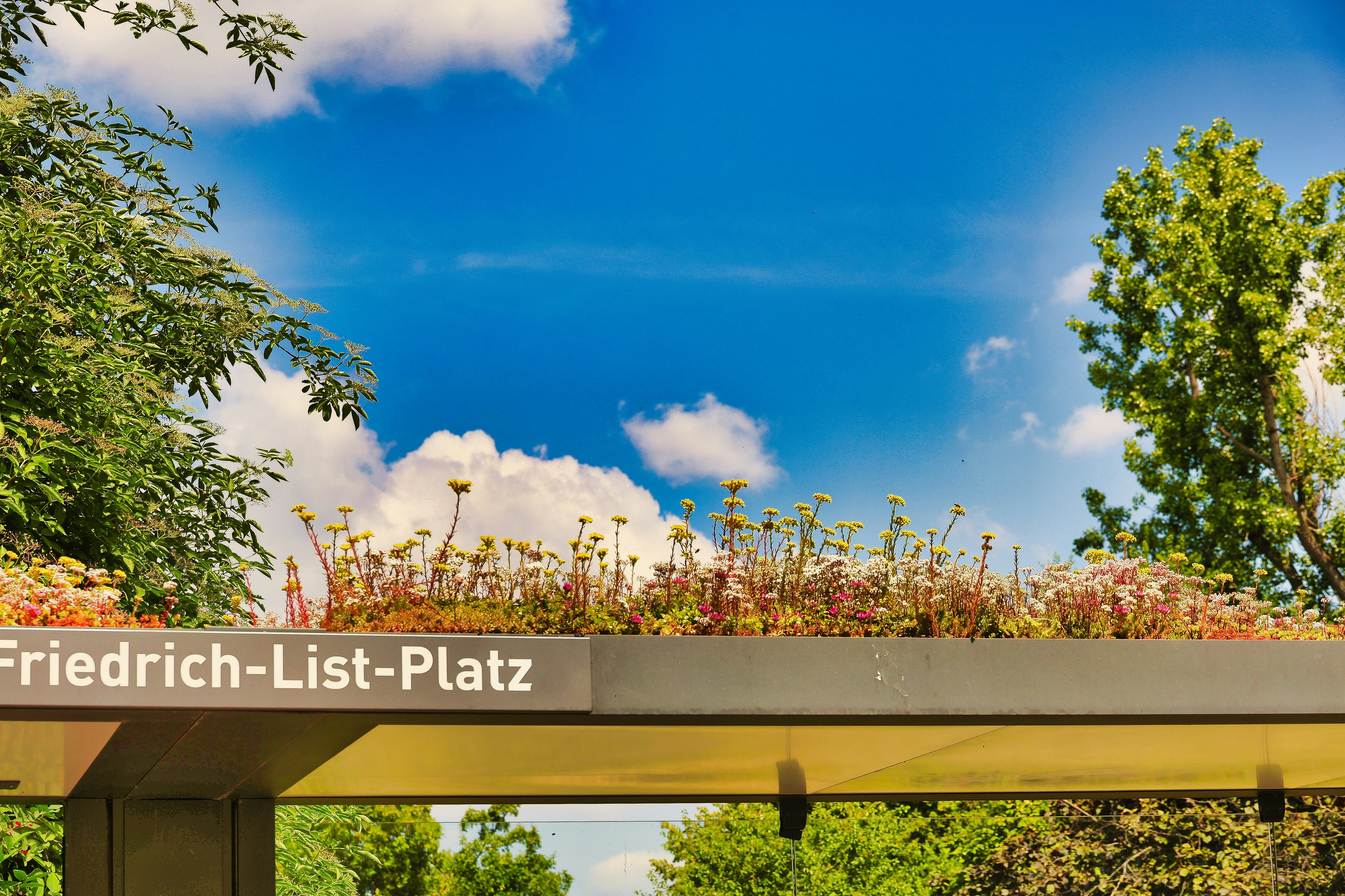 Green roof with sign reads friedrich-list-platz