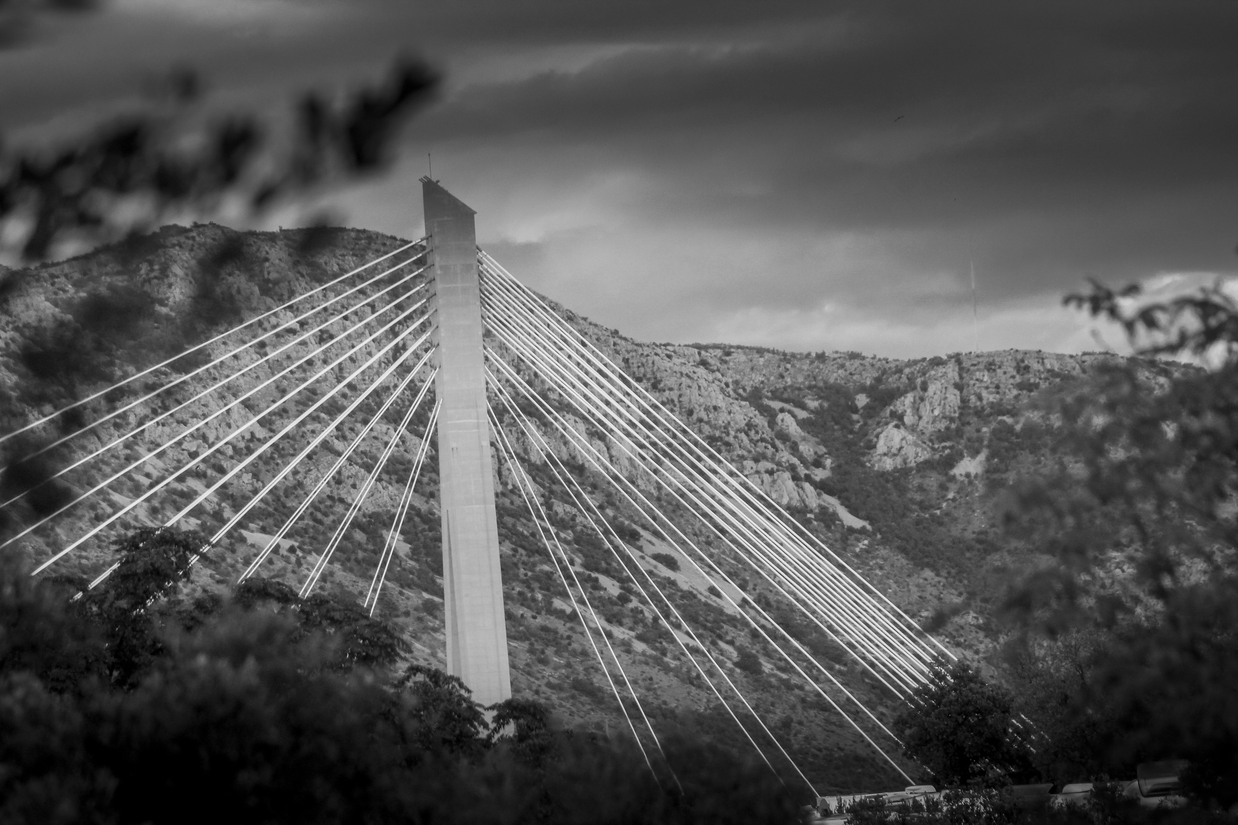 Modern cable-stayed bridge against a mountainous backdrop