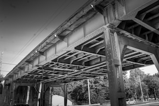 Underneath a large industrial bridge structure