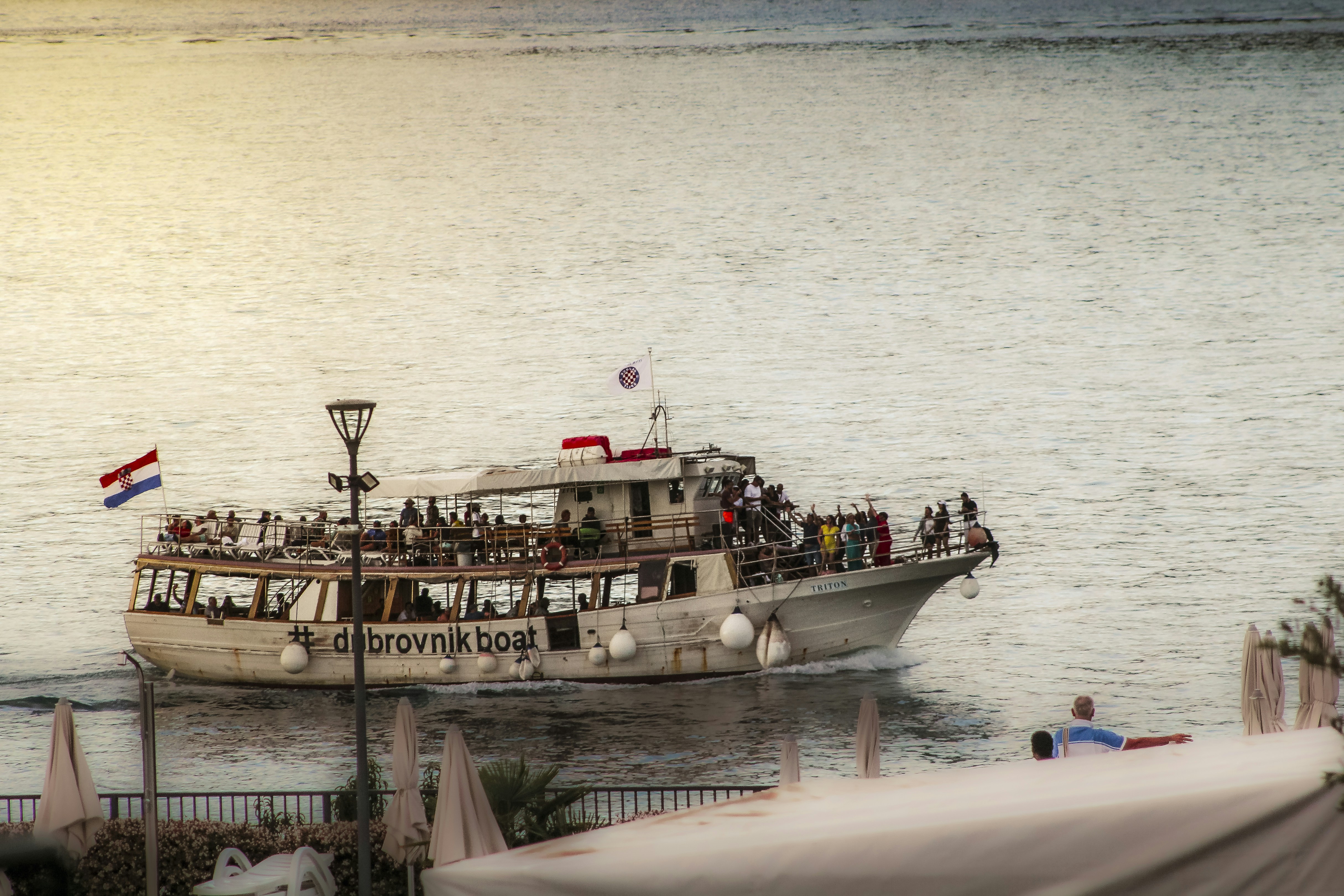 Tour boat full of people sailing on the water.