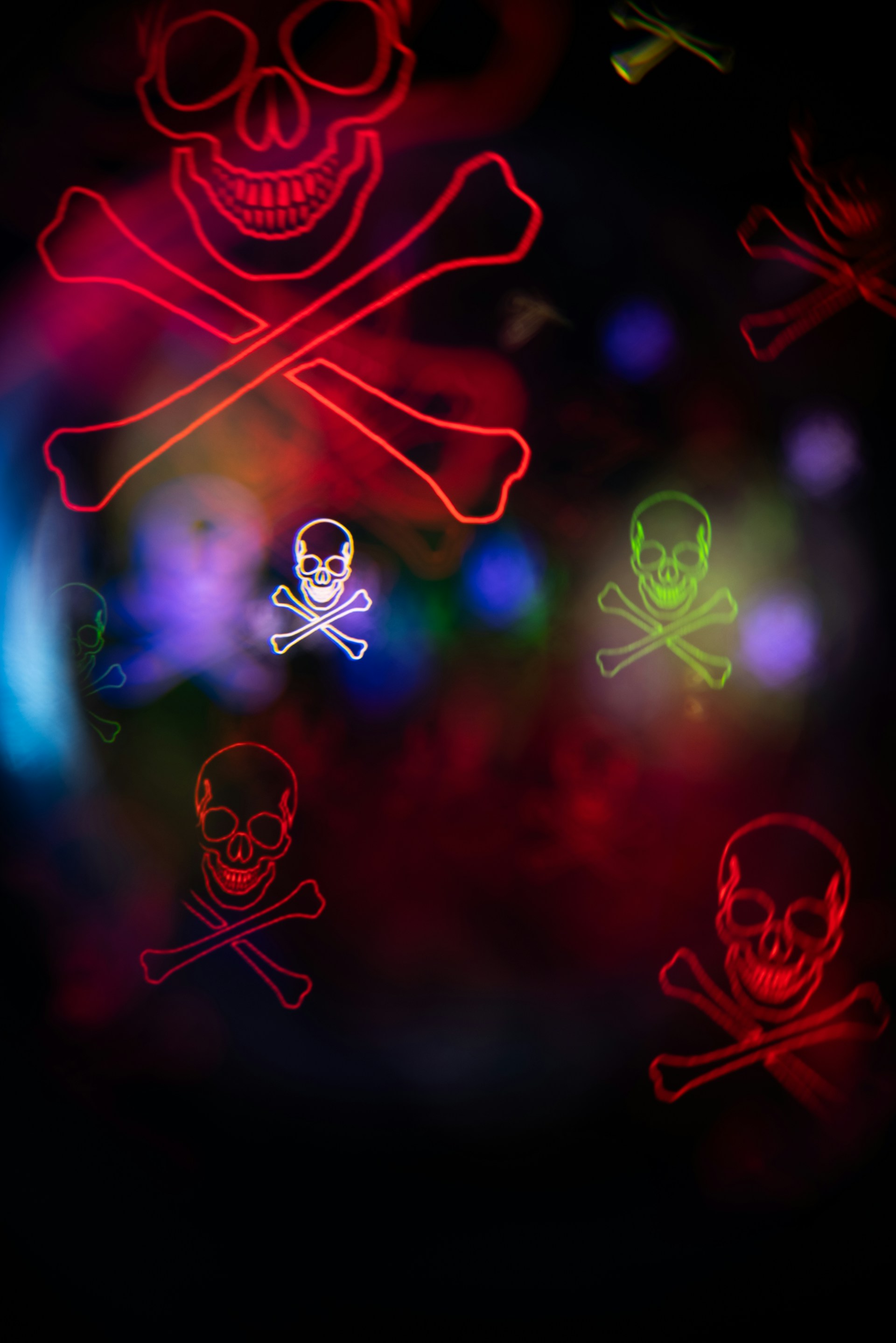 Neon skull and crossbones on a dark background