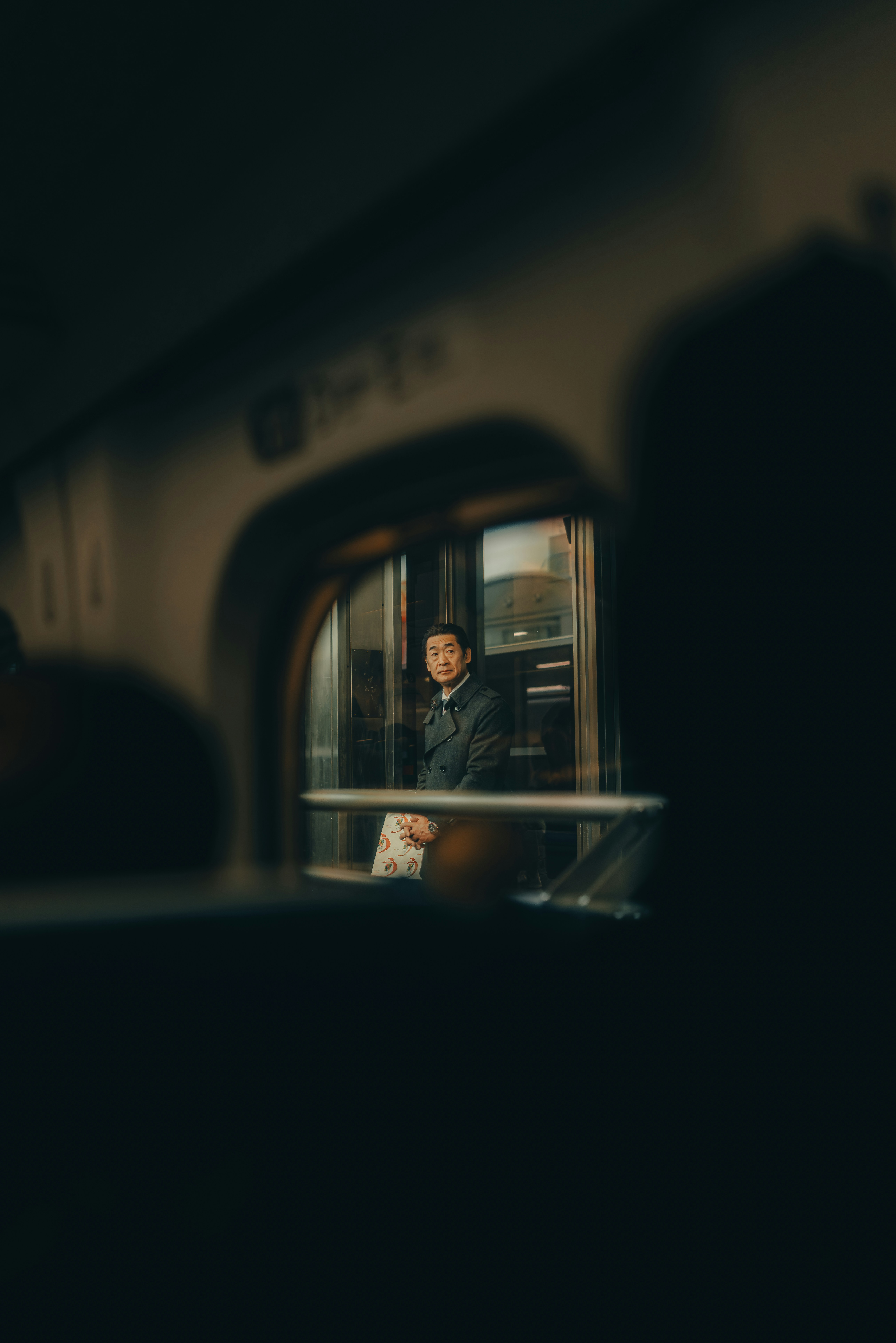 Man sitting by train window looking out