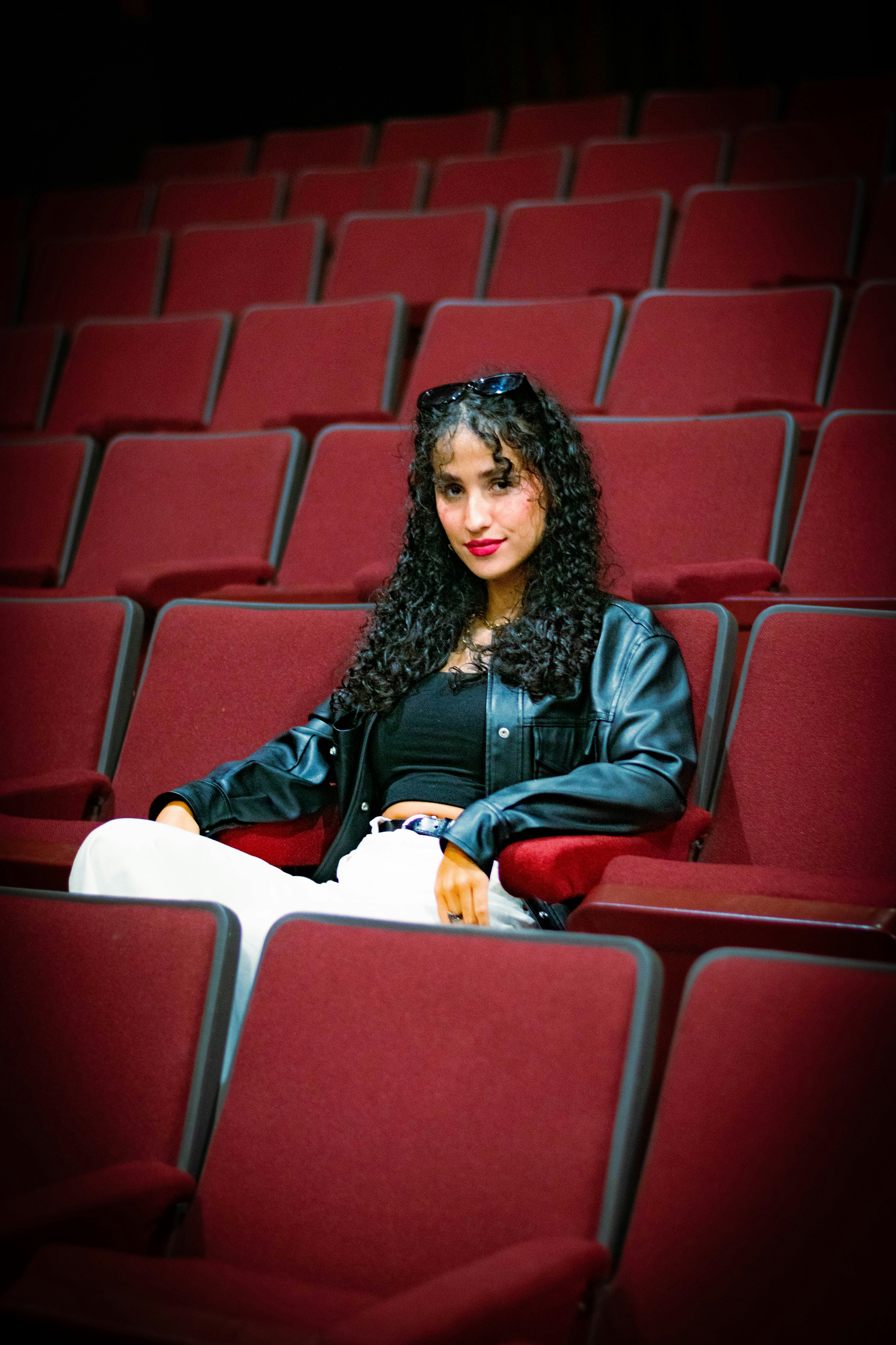 Woman sitting in an empty theater