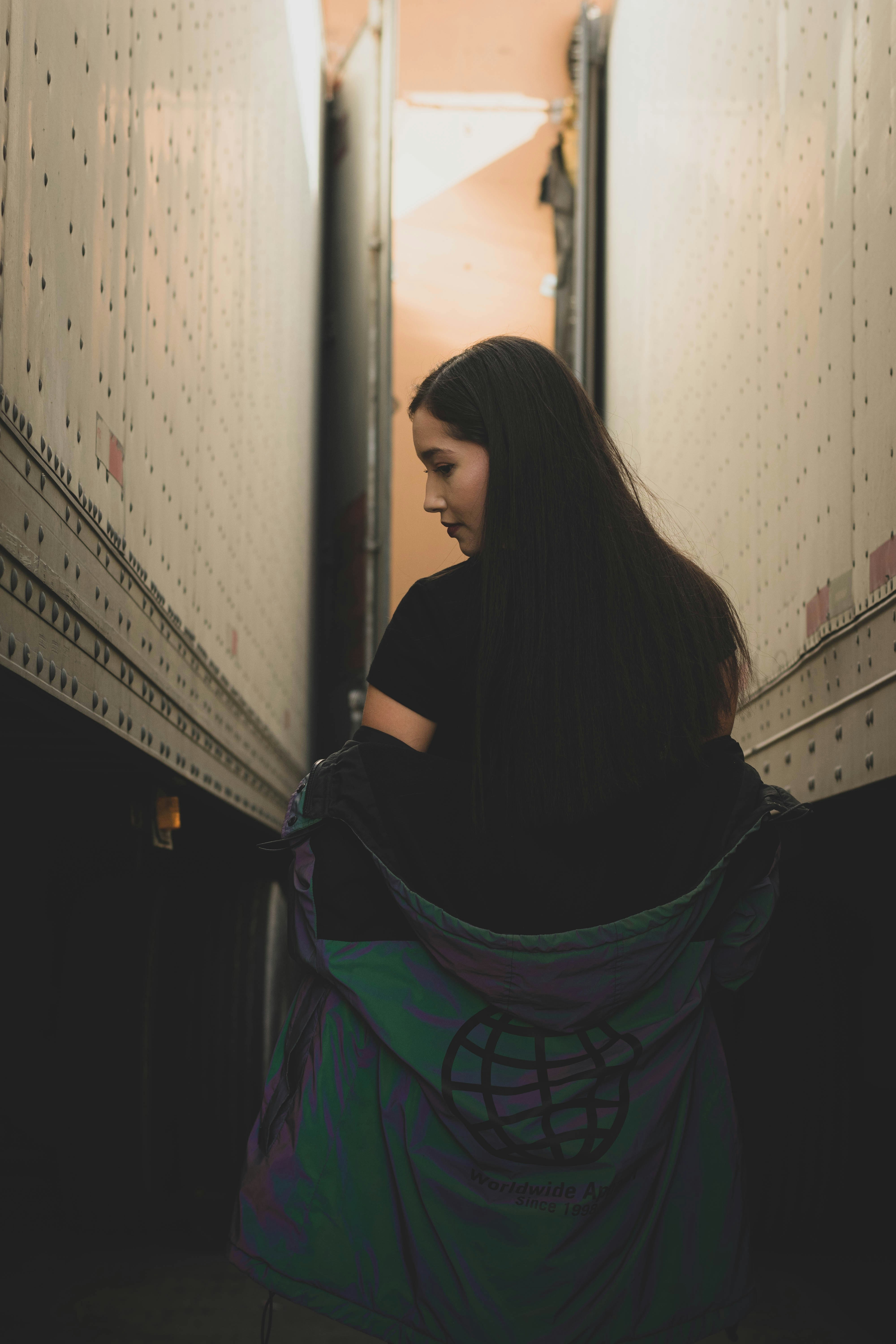 Woman standing between two semi-trailers