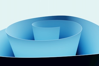 Abstract blue spiral paper sculpture with dark base