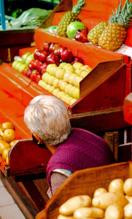 Woman browsing fruit and vegetables at a market