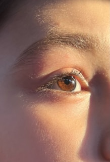 Close-up of a human eye with warm lighting.