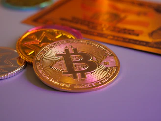 Golden bitcoin coin with other coins and card.