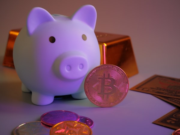 Bitcoin, coins, gold bar and piggy bank with soft colors