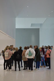 A group of people looking at a wall display.