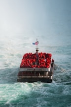 Tour boat with many people wearing red jackets