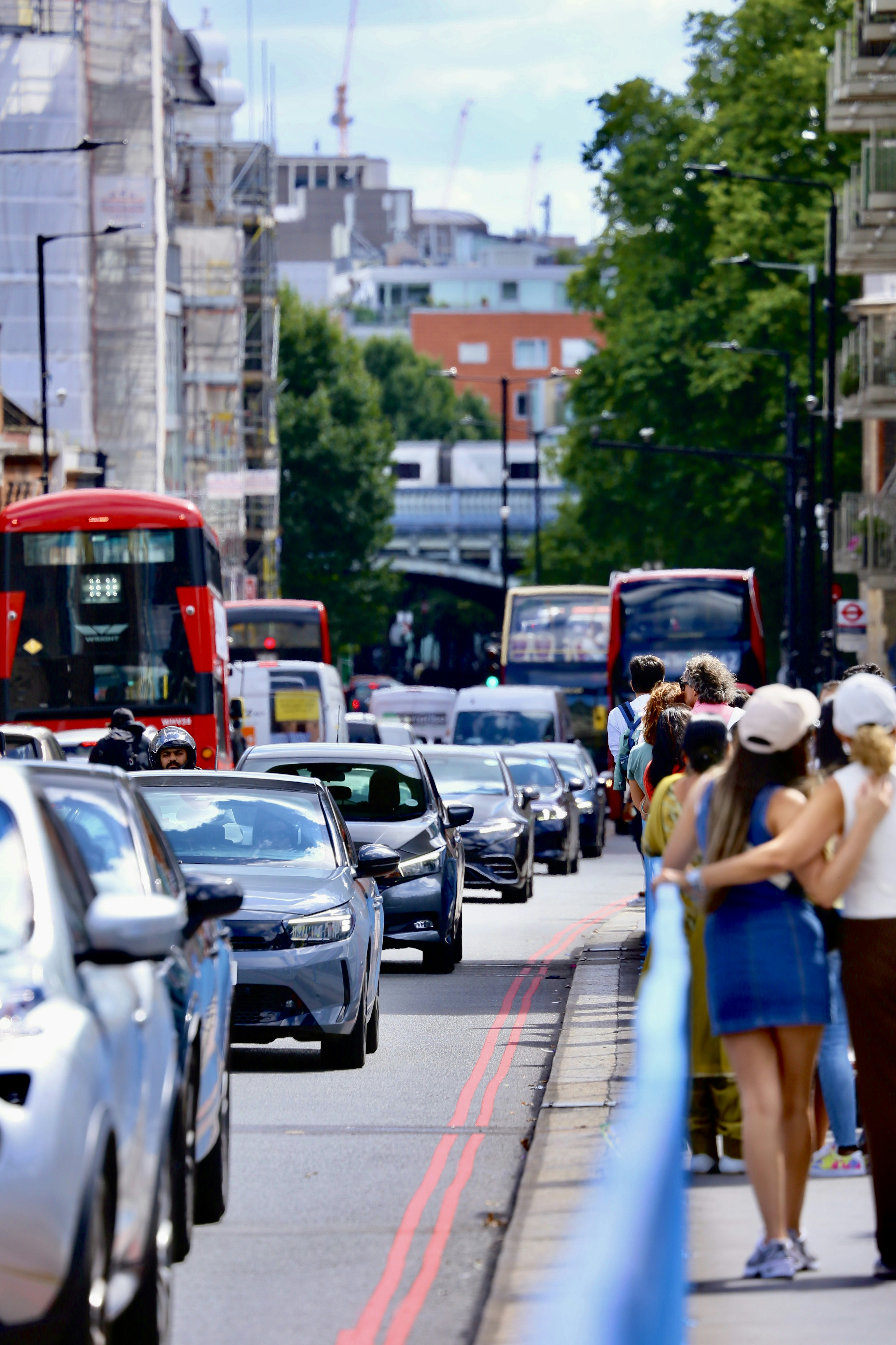 Traffic jam on a city street with people walking