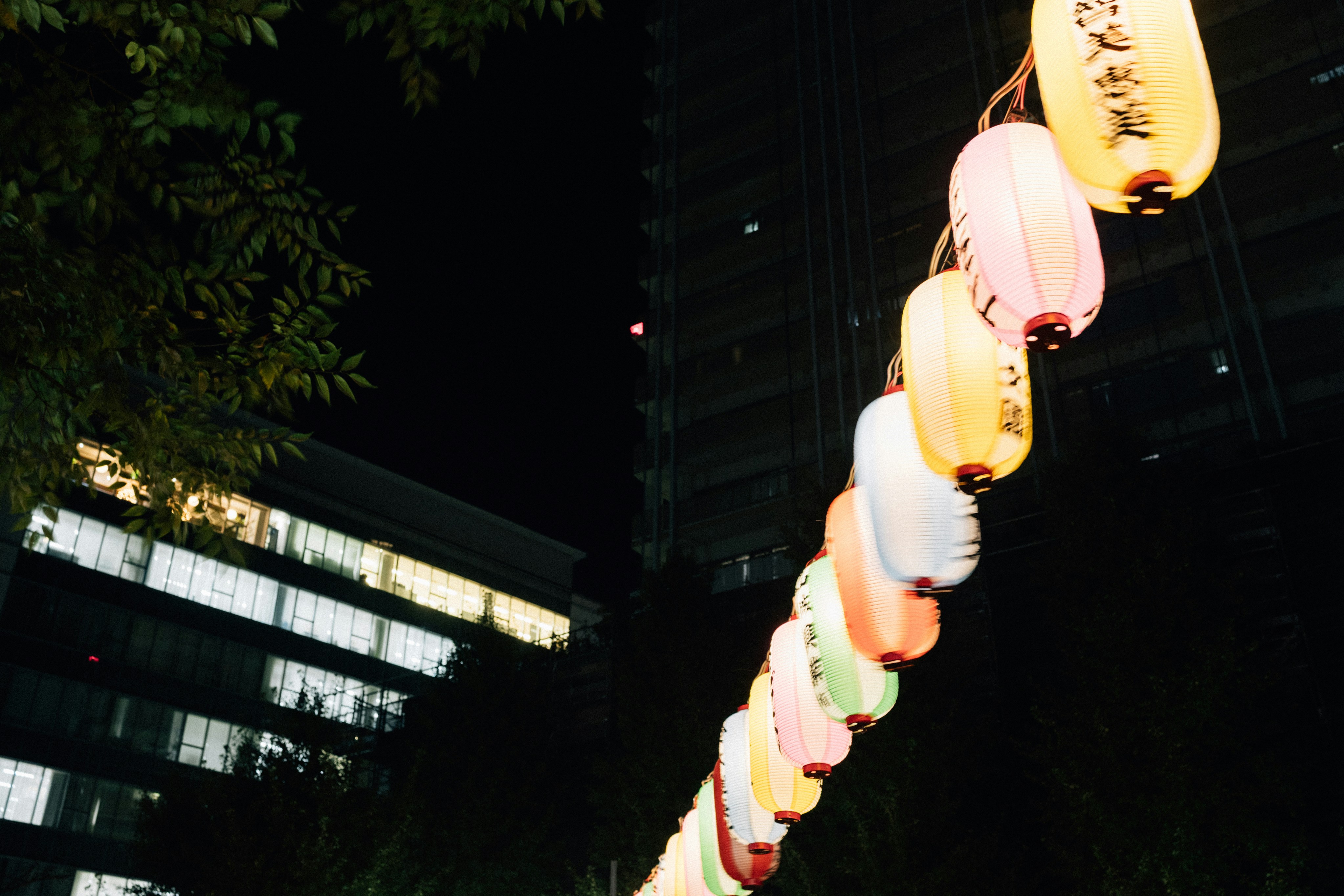 A string of colorful lanterns at night