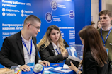 People at a business exhibition interacting with a booth.