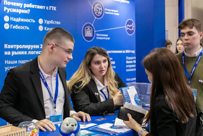 People at a business exhibition interacting with a booth.