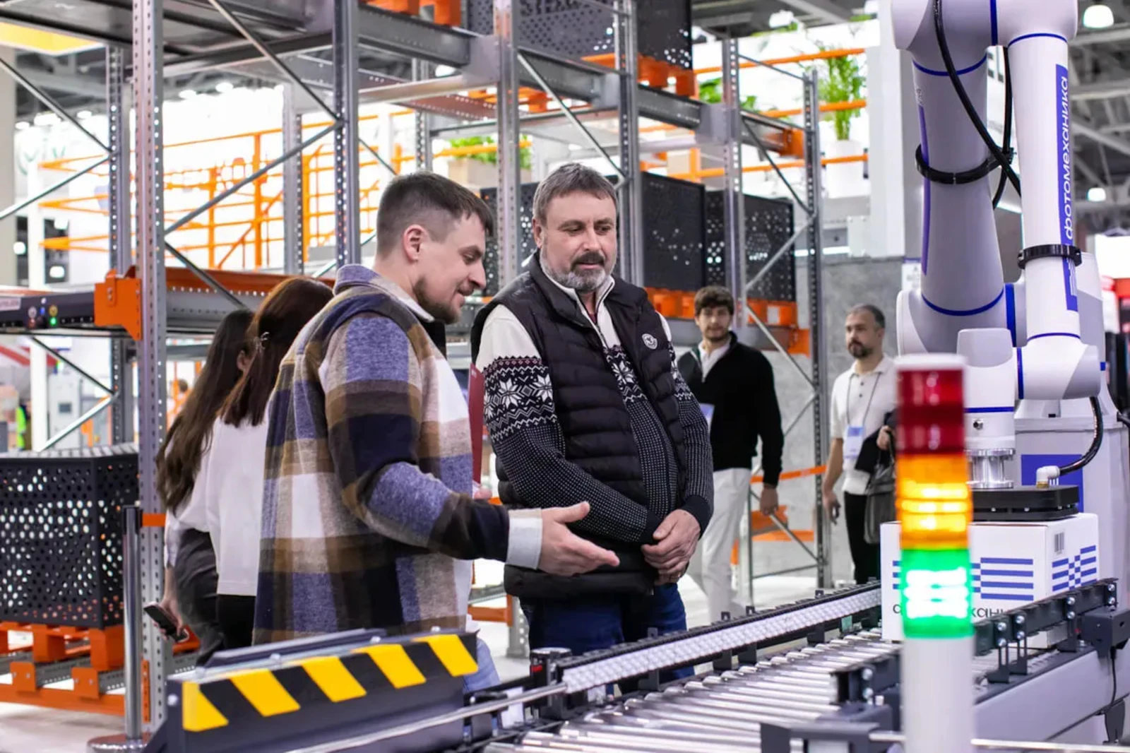 Engineers reviewing an automated conveyor system in a warehouse