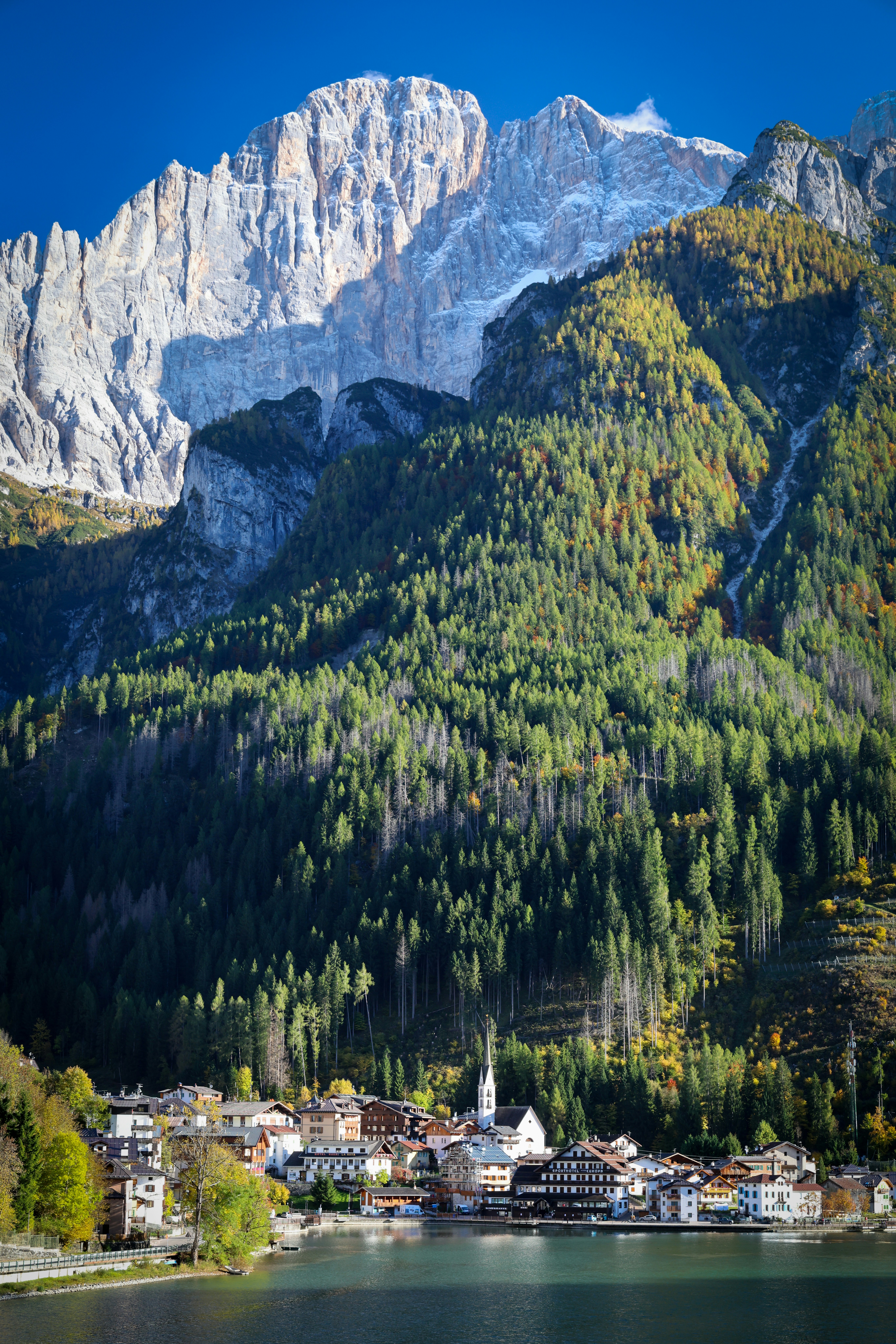 Mountain village nestled beside a lake and forest