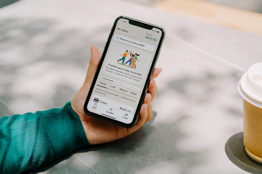 Person holding a smartphone with an app open.