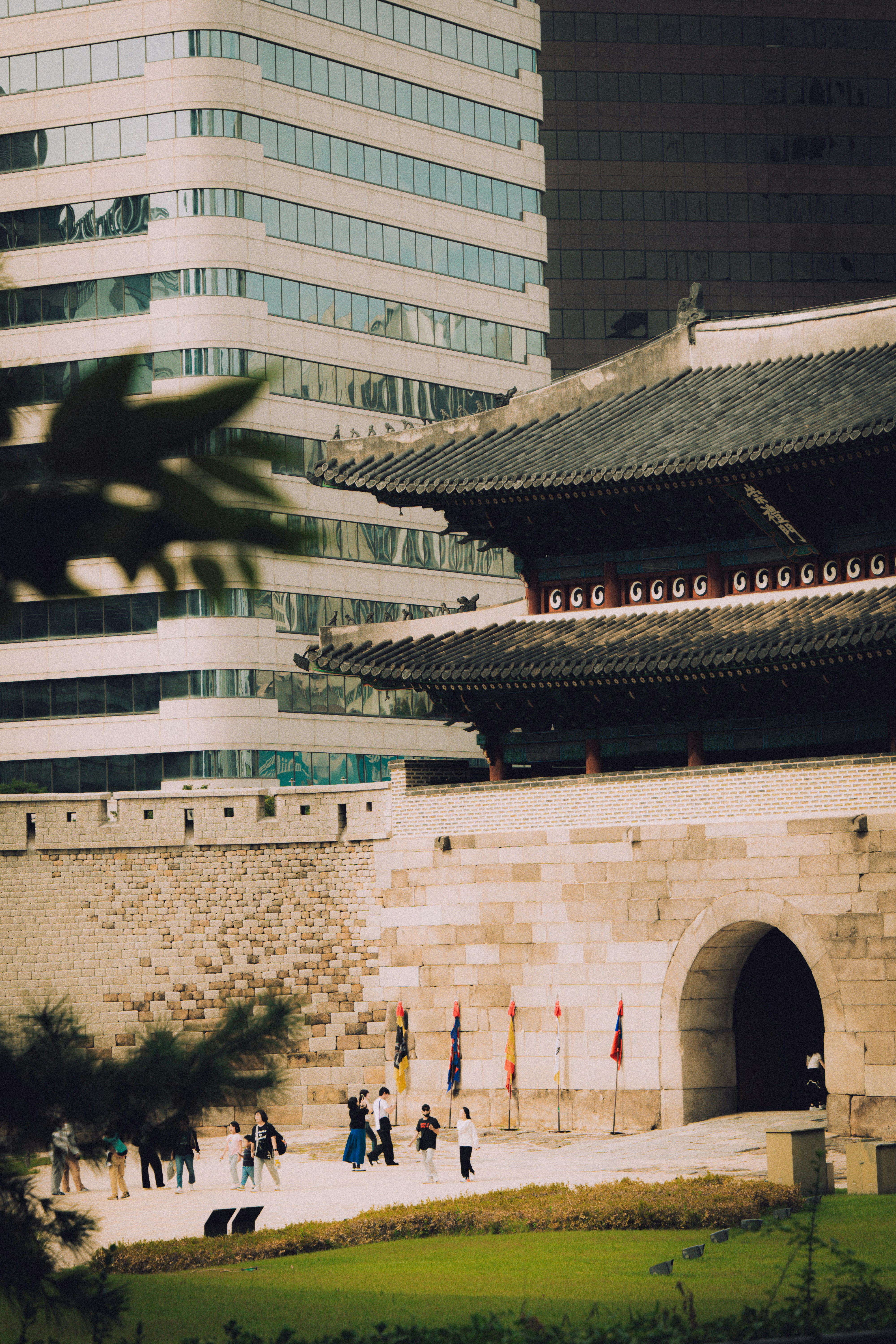 Traditional gate stands before modern buildings