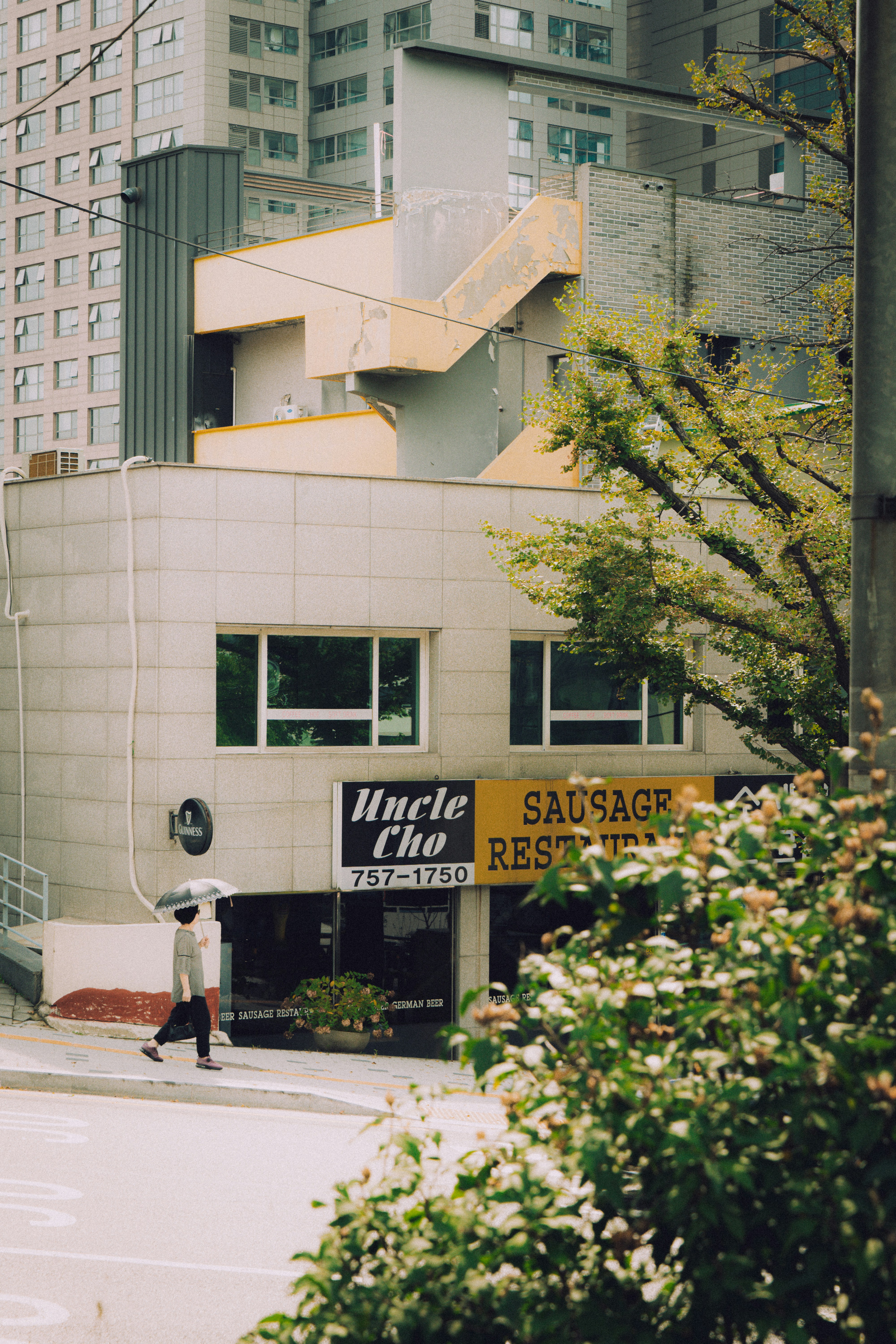 Person walks past uncle cho sausage restaurant building