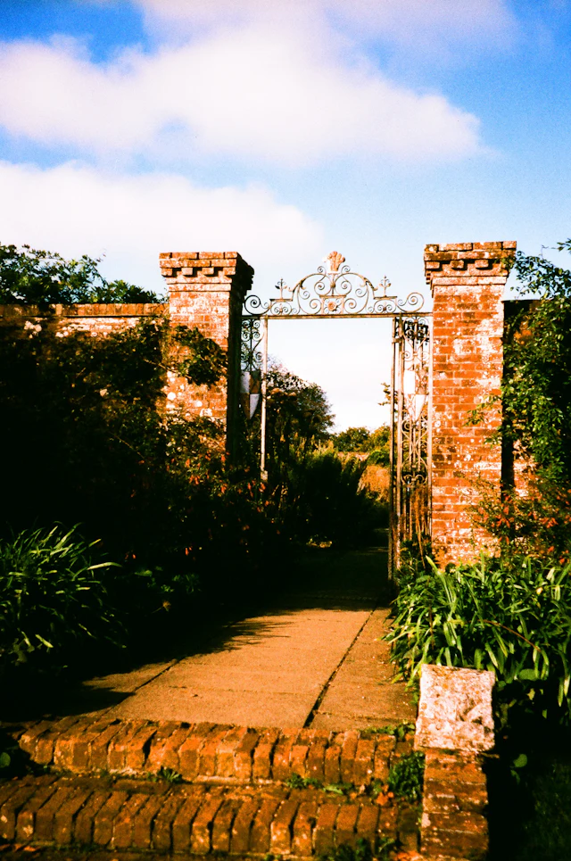 Ornate gate leading into a lush garden