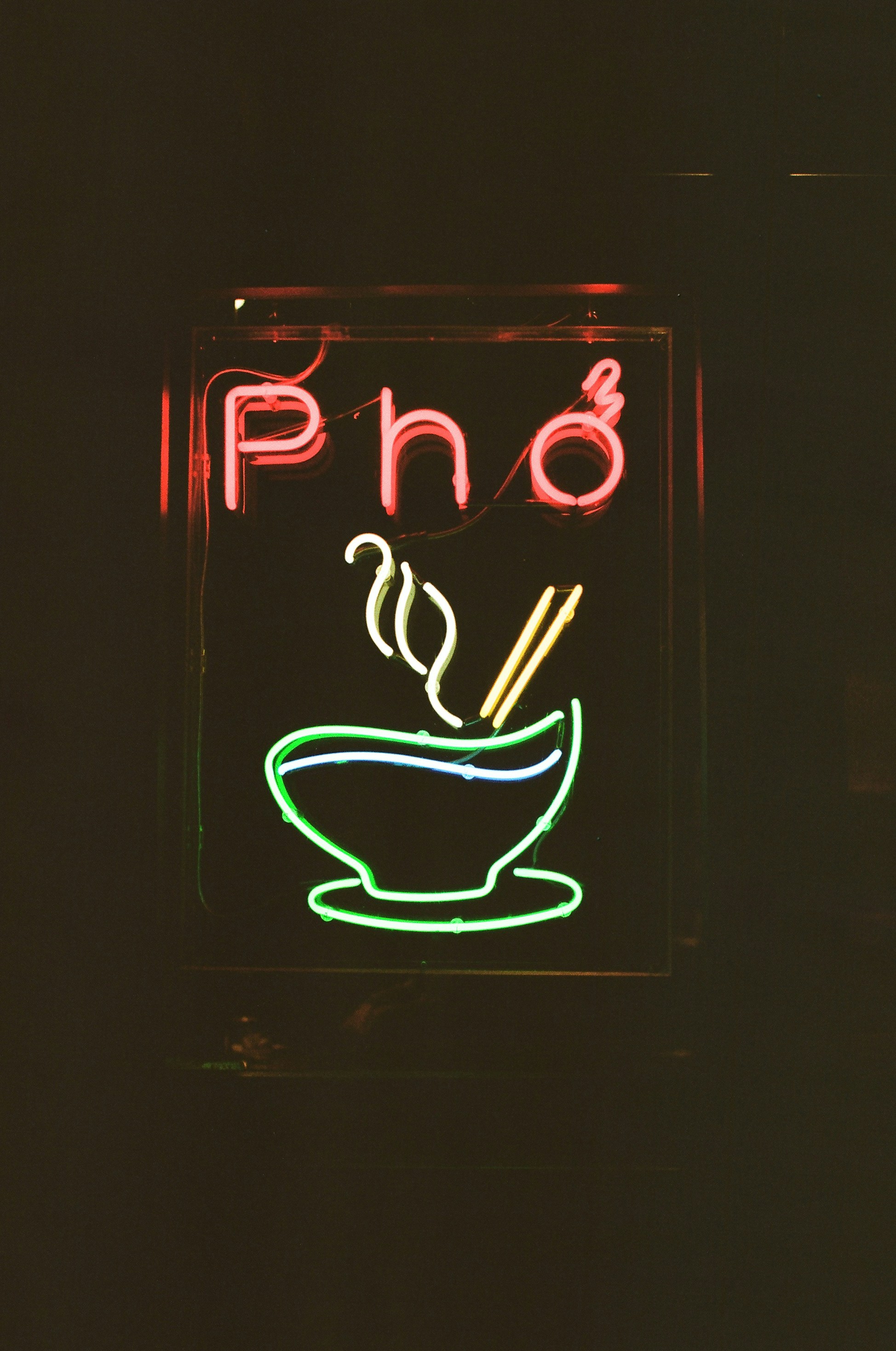 Neon sign for pho restaurant at night