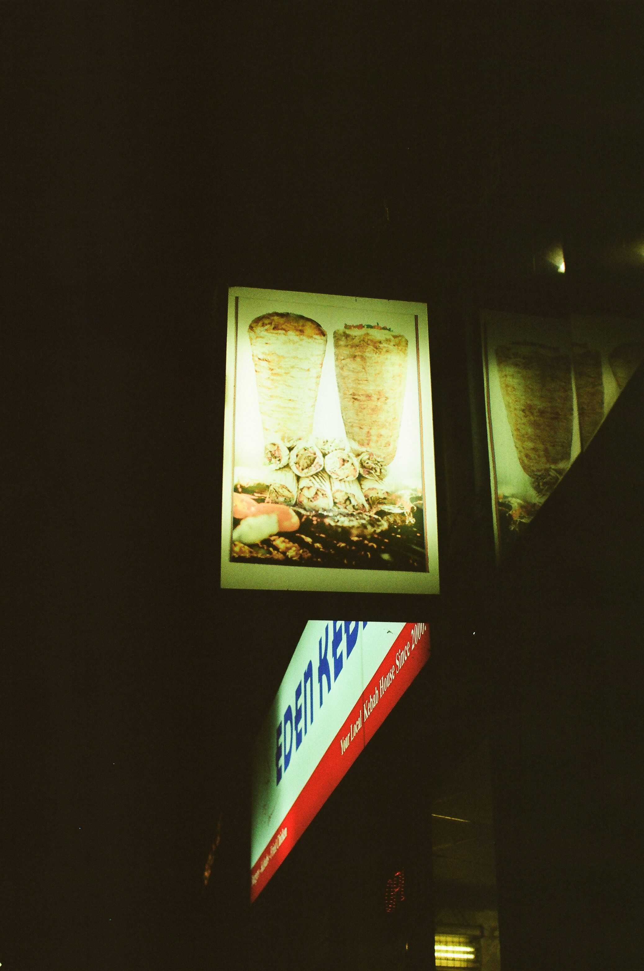 Kebab shop sign with rotating meat skewers