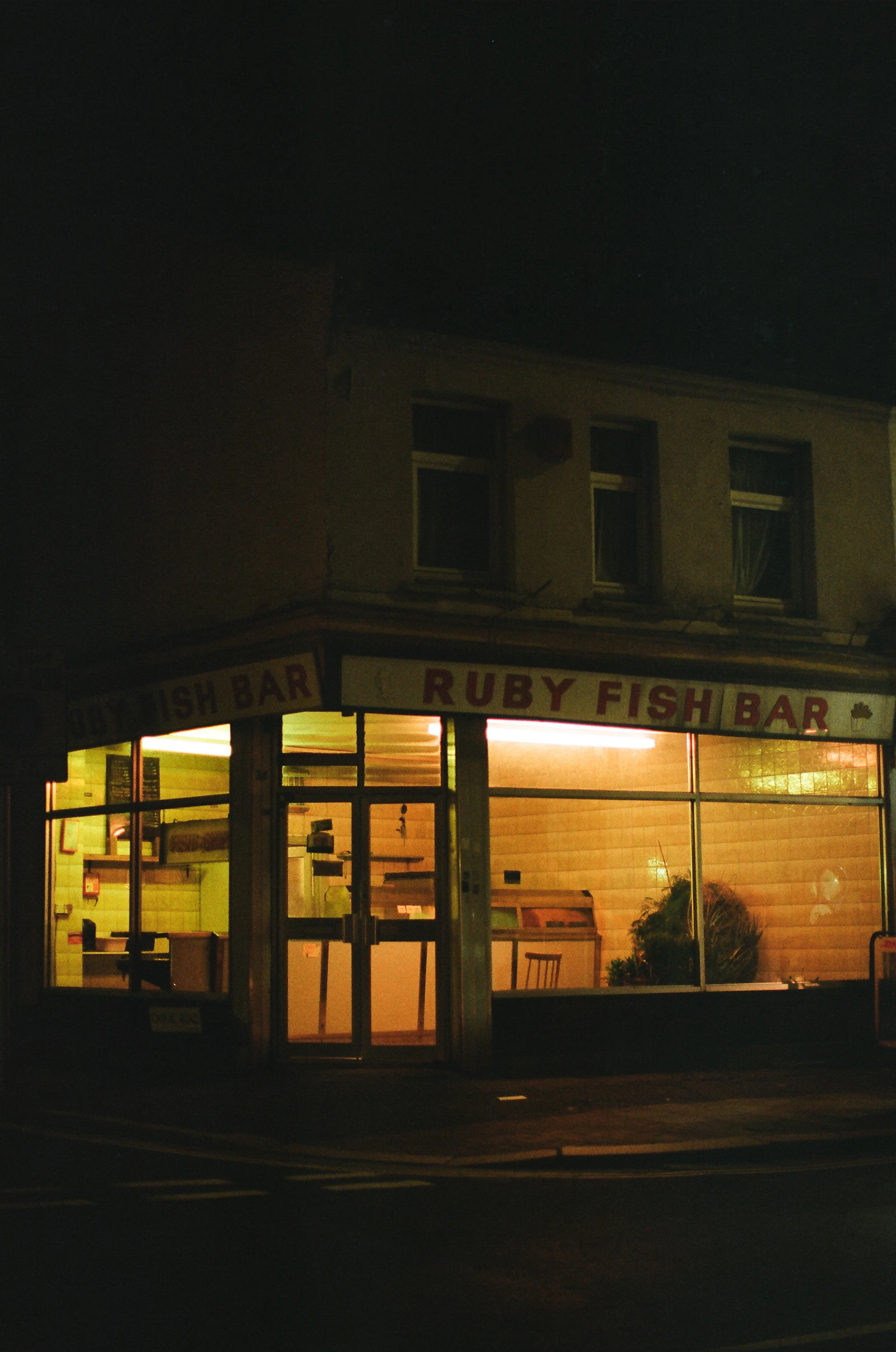 A restaurant storefront lit up in the evening