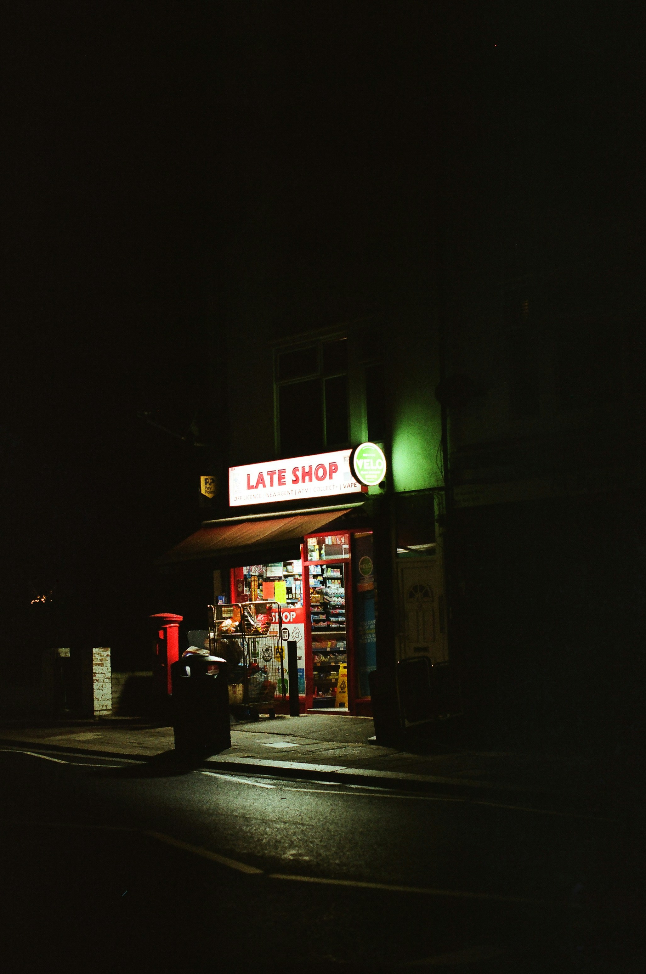A brightly lit late shop at night