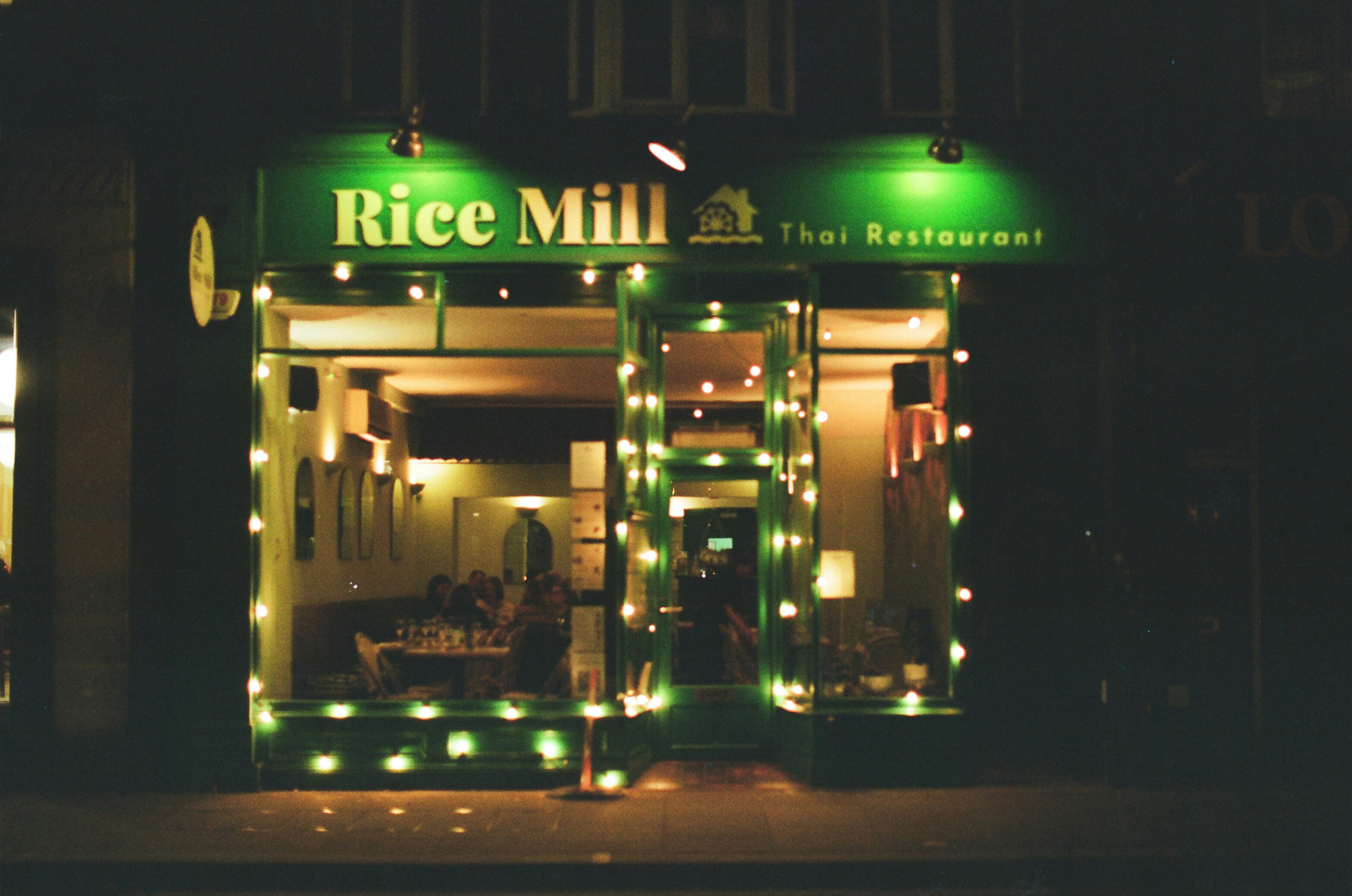 Rice mill thai restaurant entrance at night