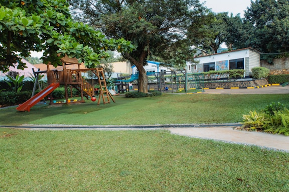 Playground with slide and swings in grassy area