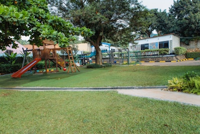 Playground with slide and swings in grassy area