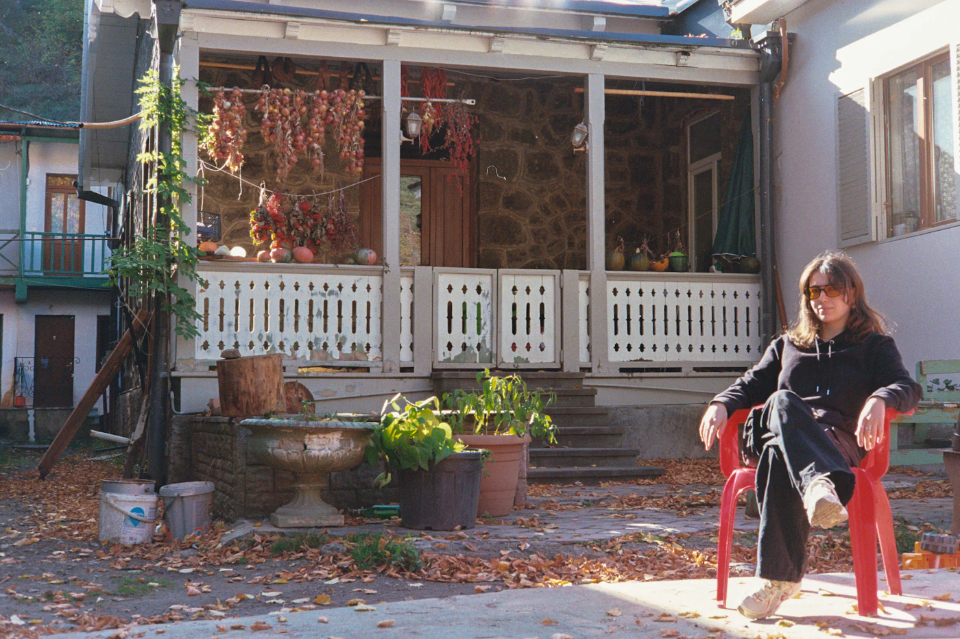 Older woman sitting on the front porch of her home