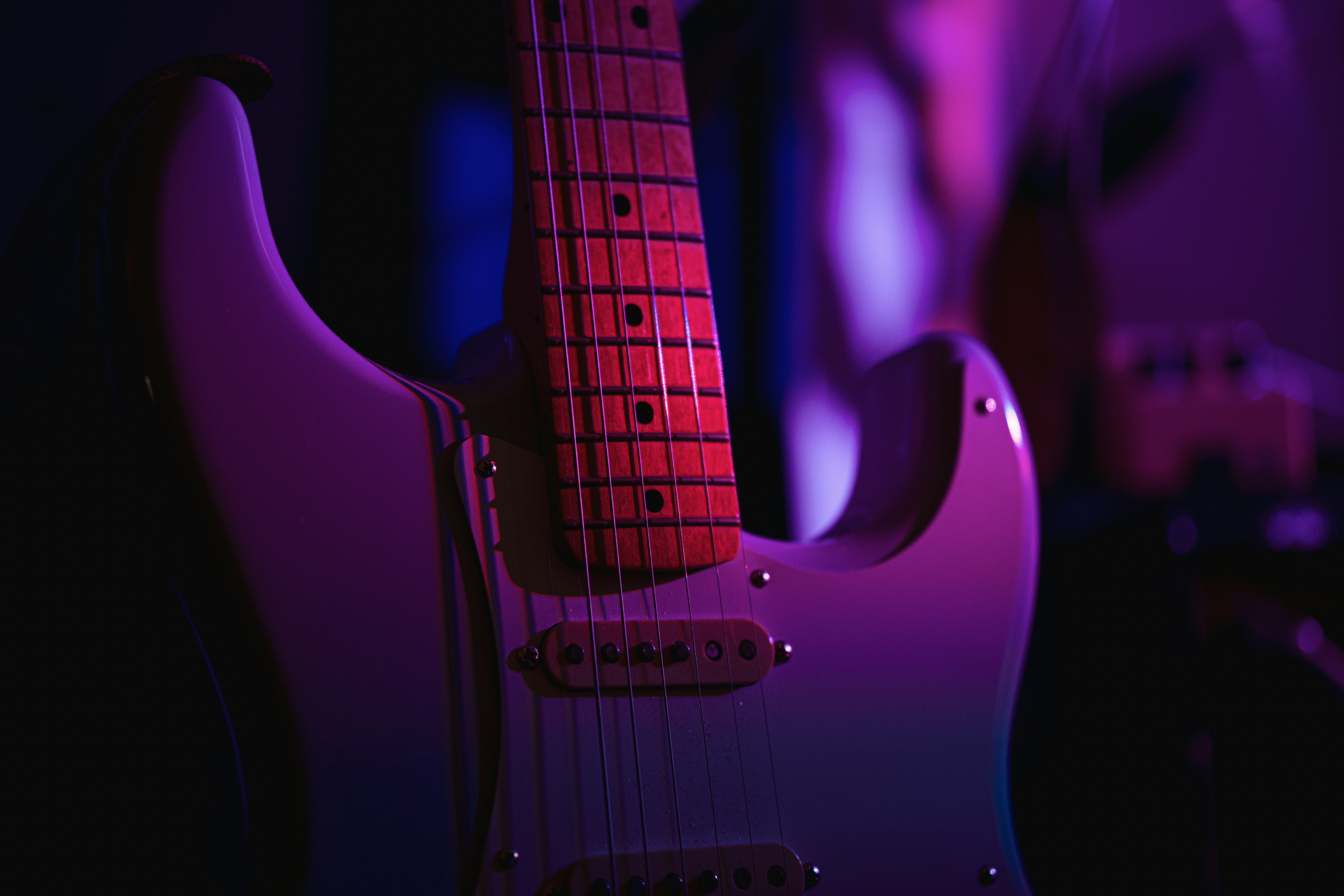 Electric guitar with purple and pink lighting