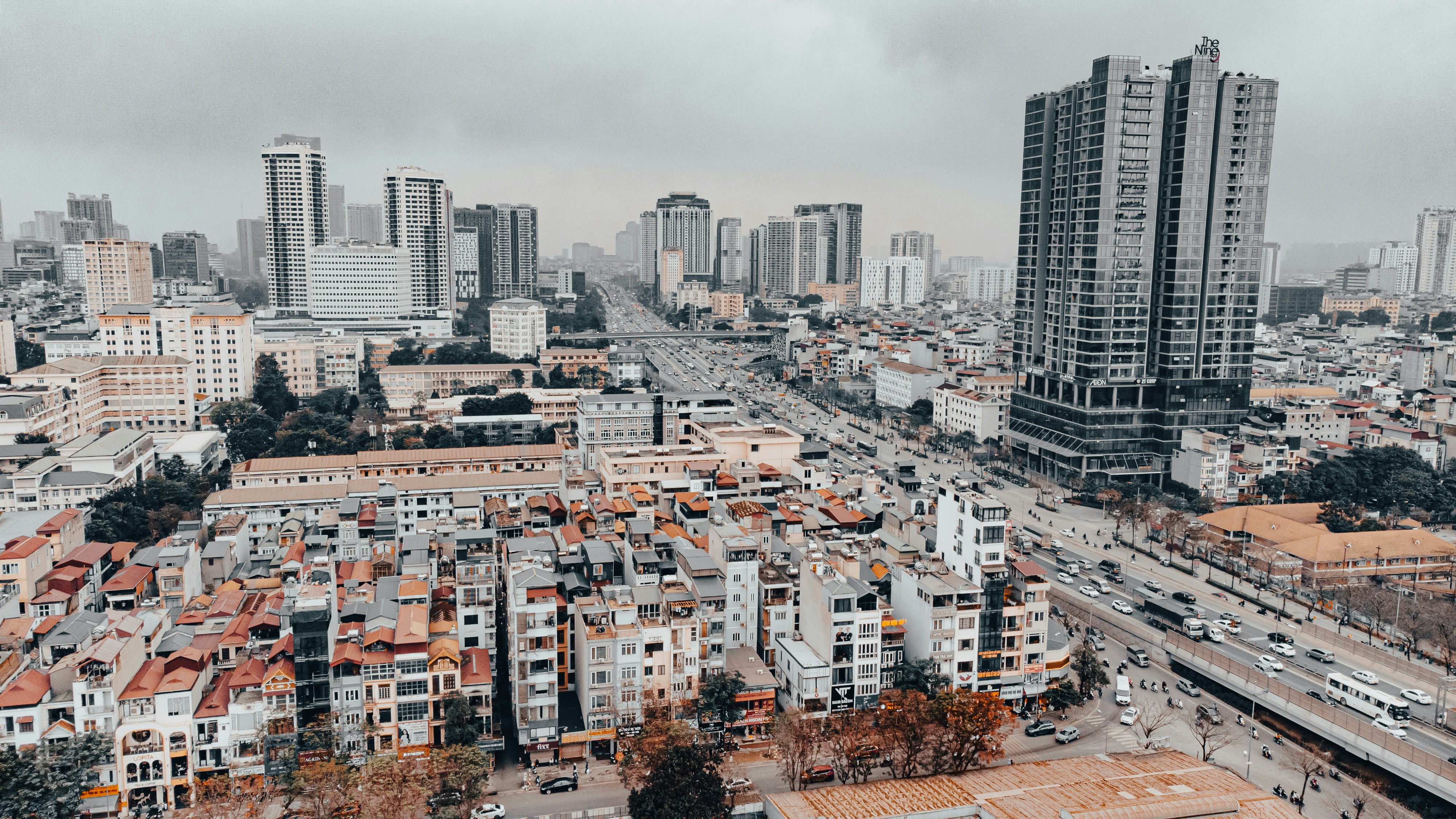 Cityscape with tall buildings and busy street below.