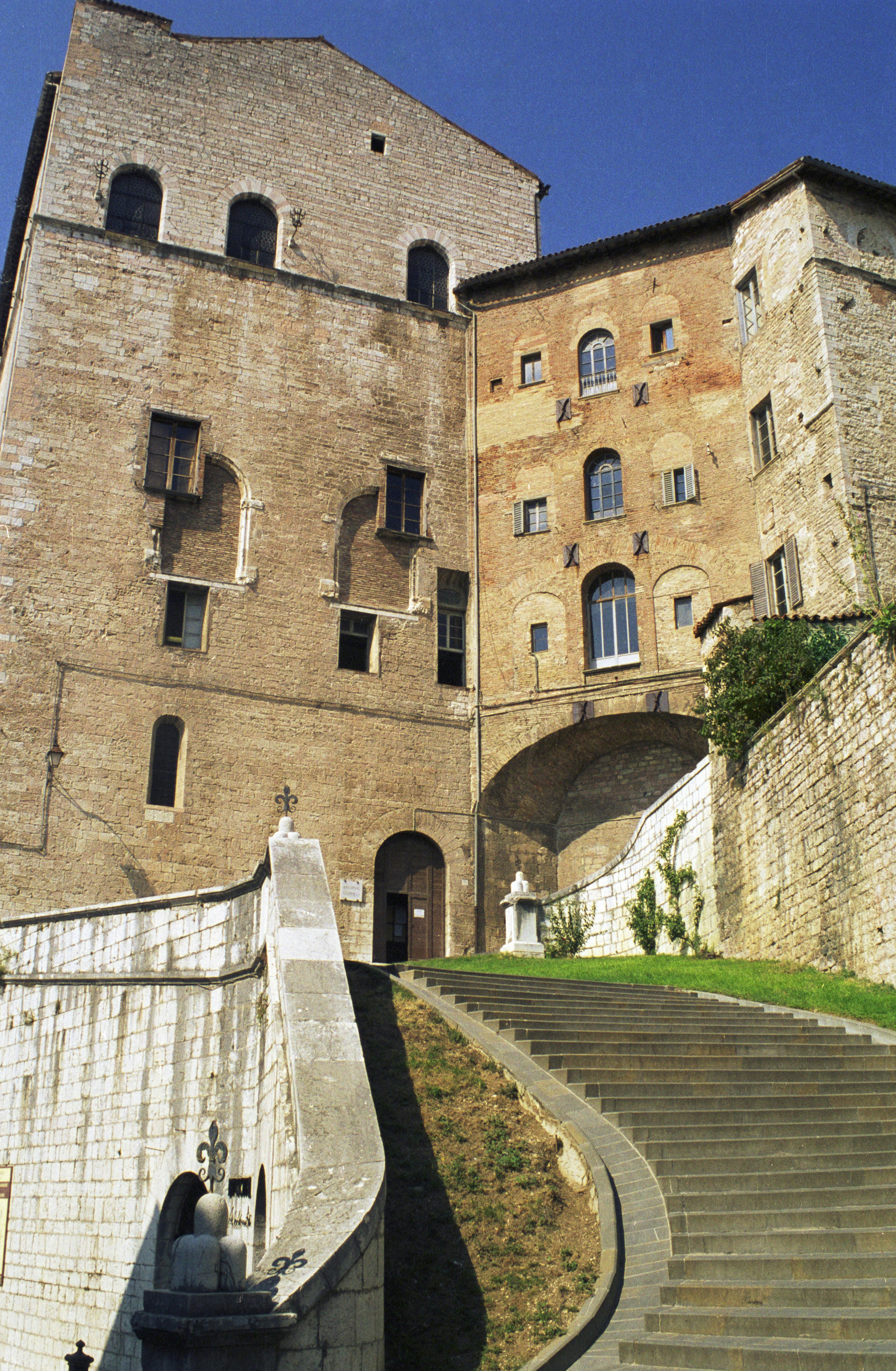 Stone staircase leading to old brick buildings