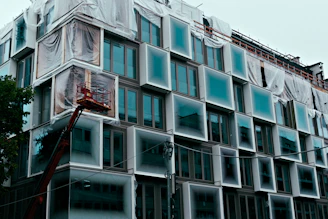 Modern building under construction with unique window design.