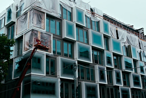 Modern building under construction with unique window design.