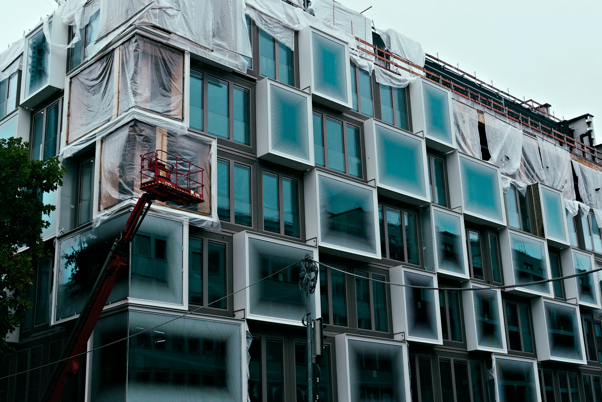 Modern building under construction with unique window design.