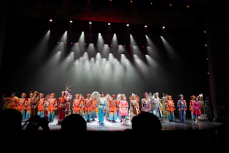 Performers in colorful costumes on a stage.