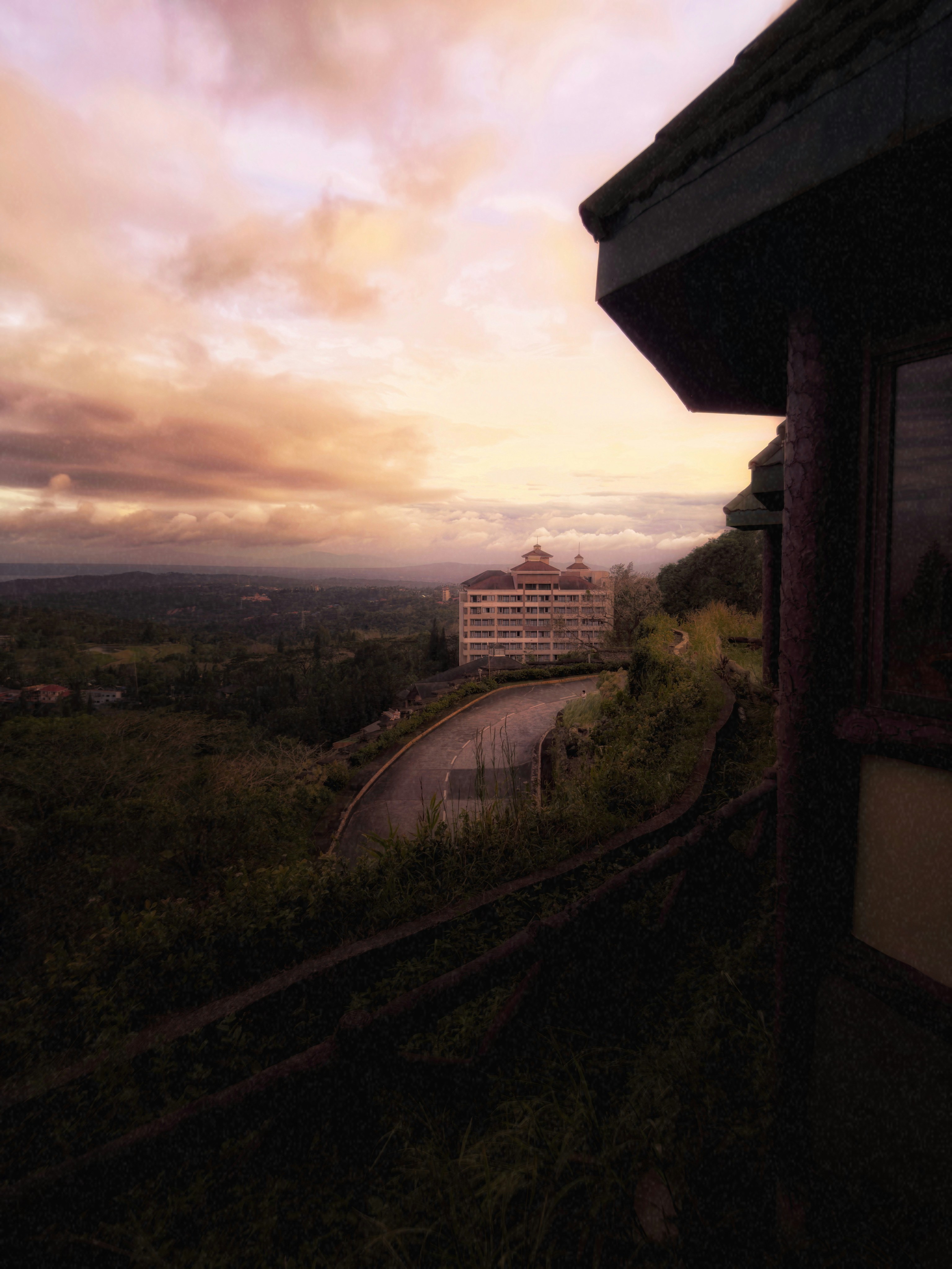 Hotel on a hill with sunset sky