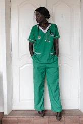 A woman in green scrubs with a stethoscope