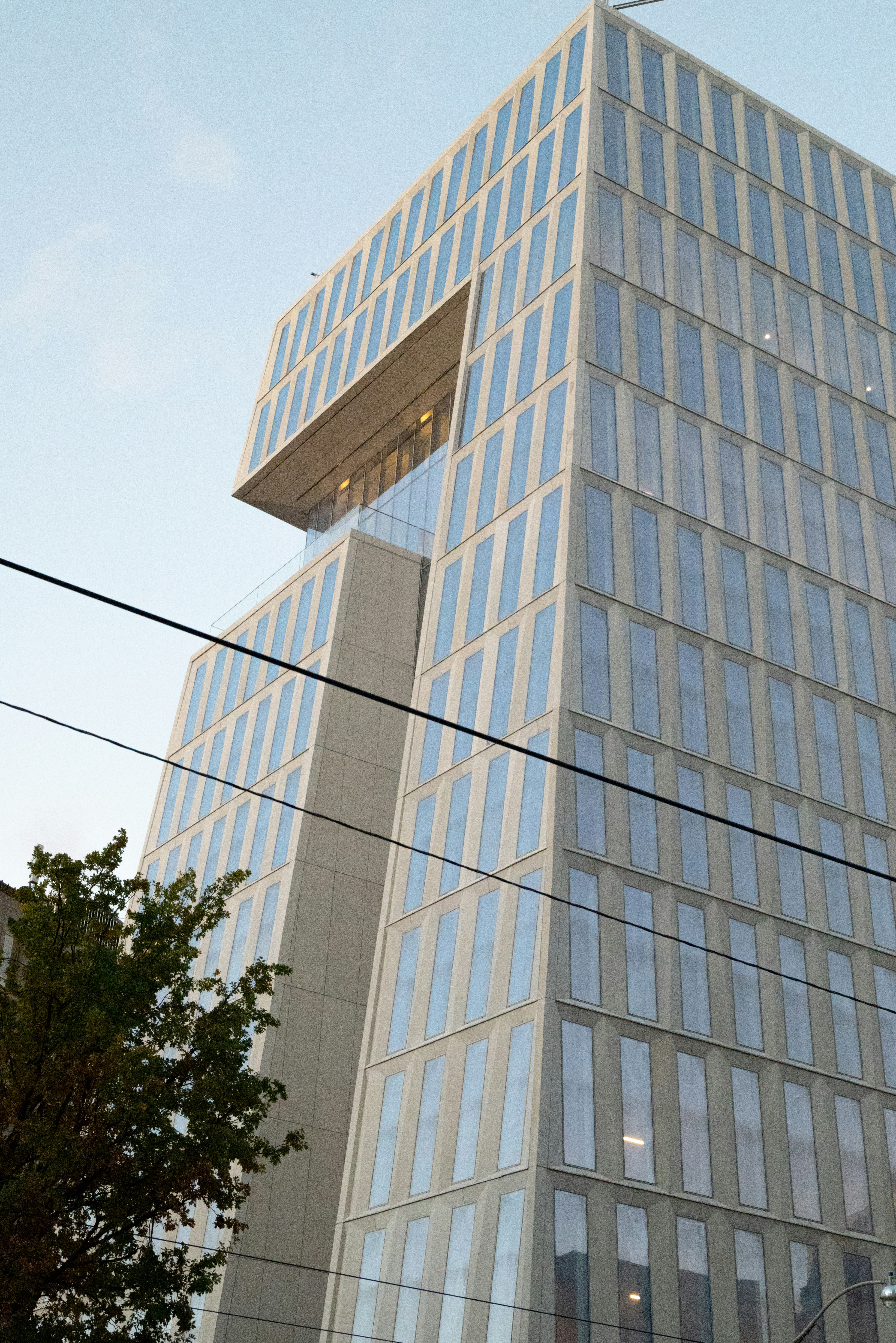 Modern glass building with geometric design.