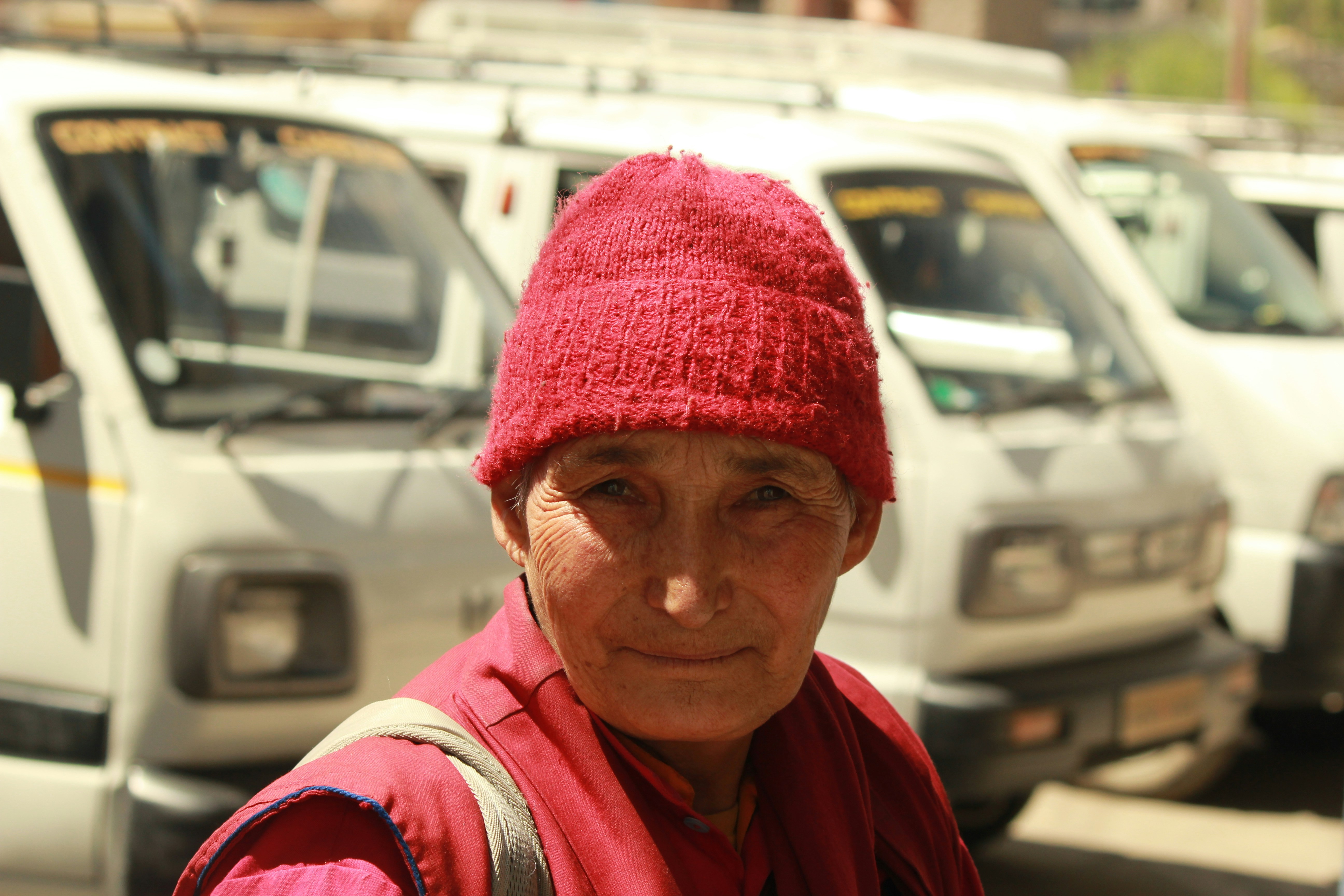 Elderly woman in red hat and robes