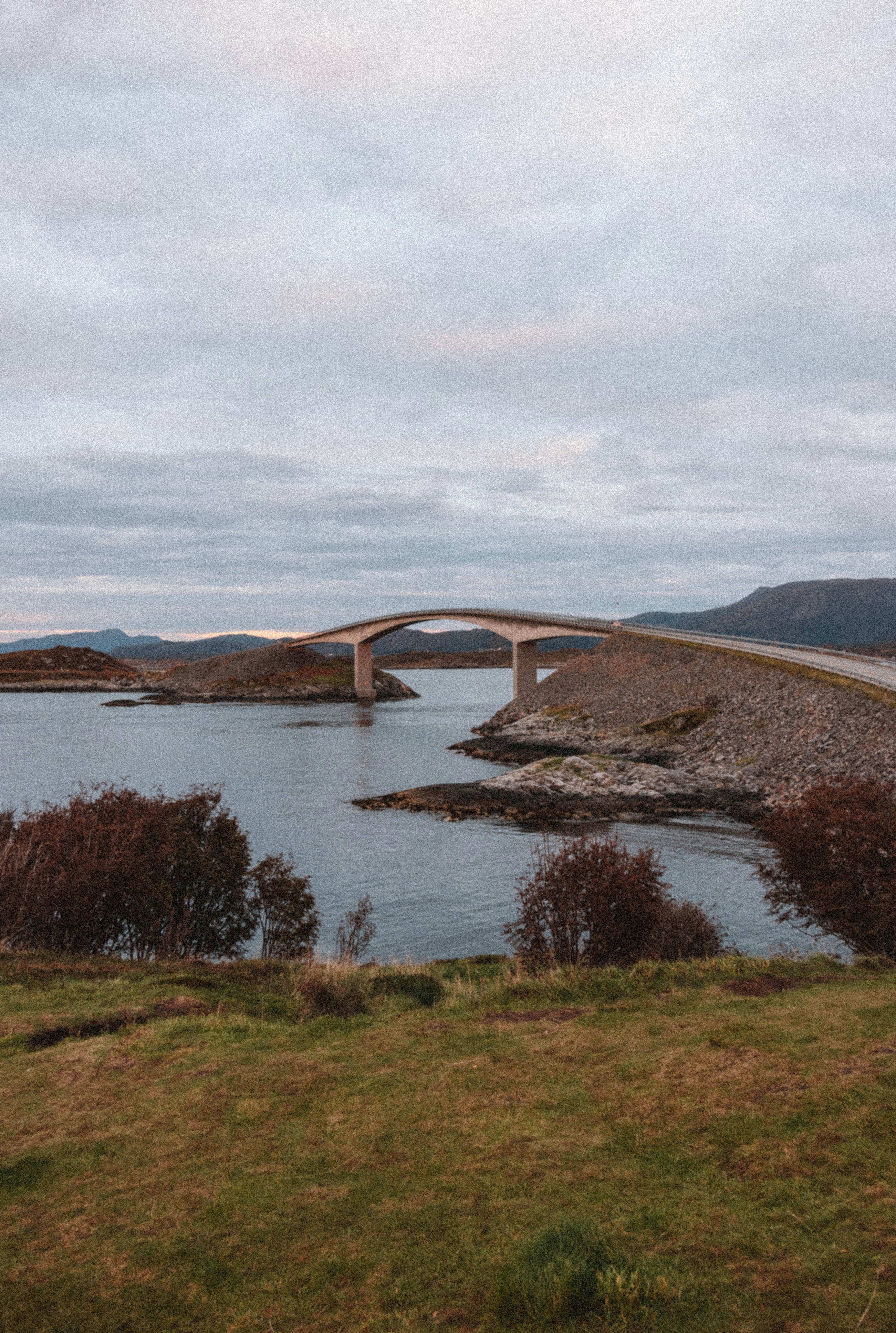 A bridge crosses a calm body of water.