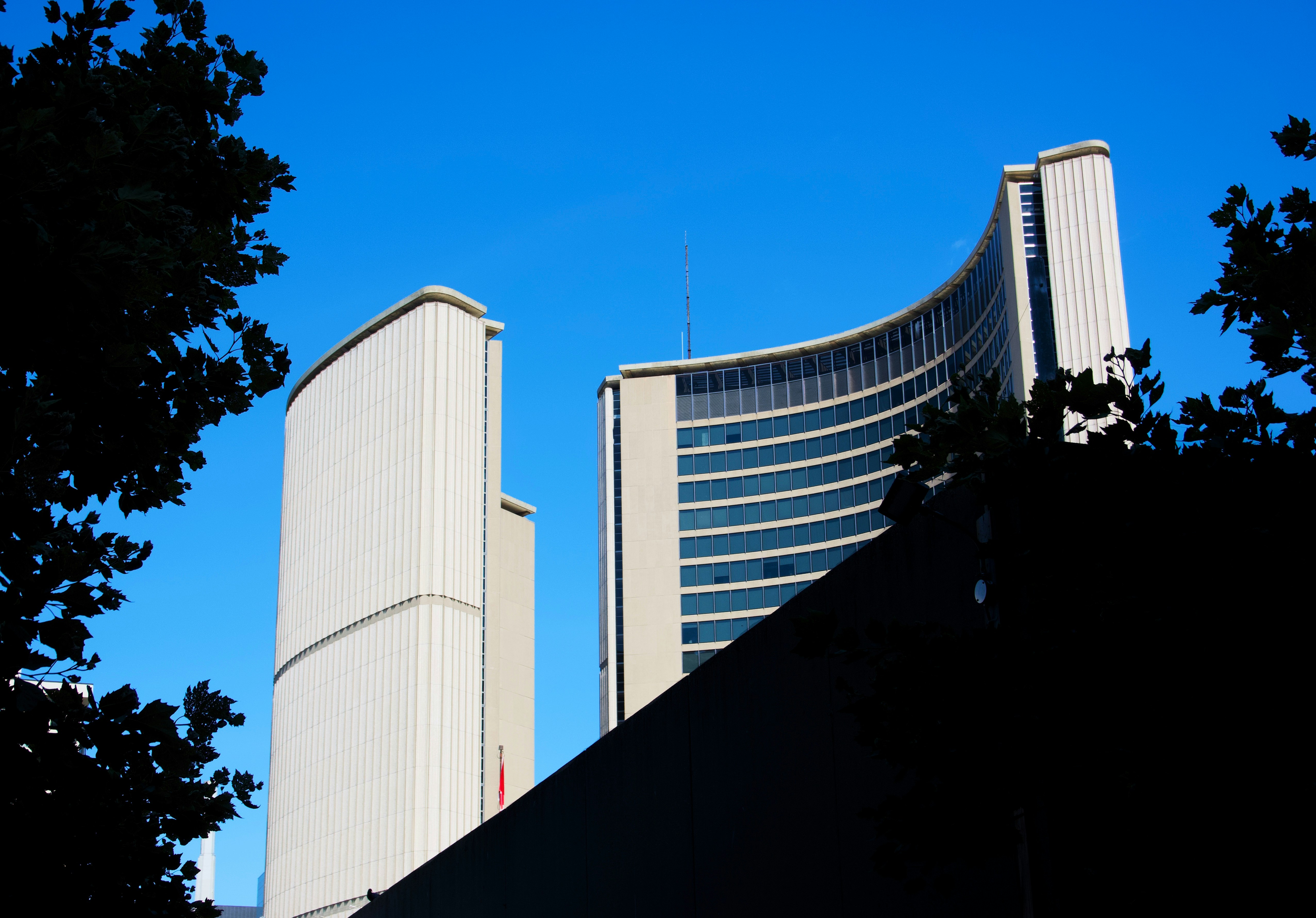 Modern curved buildings against a clear blue sky