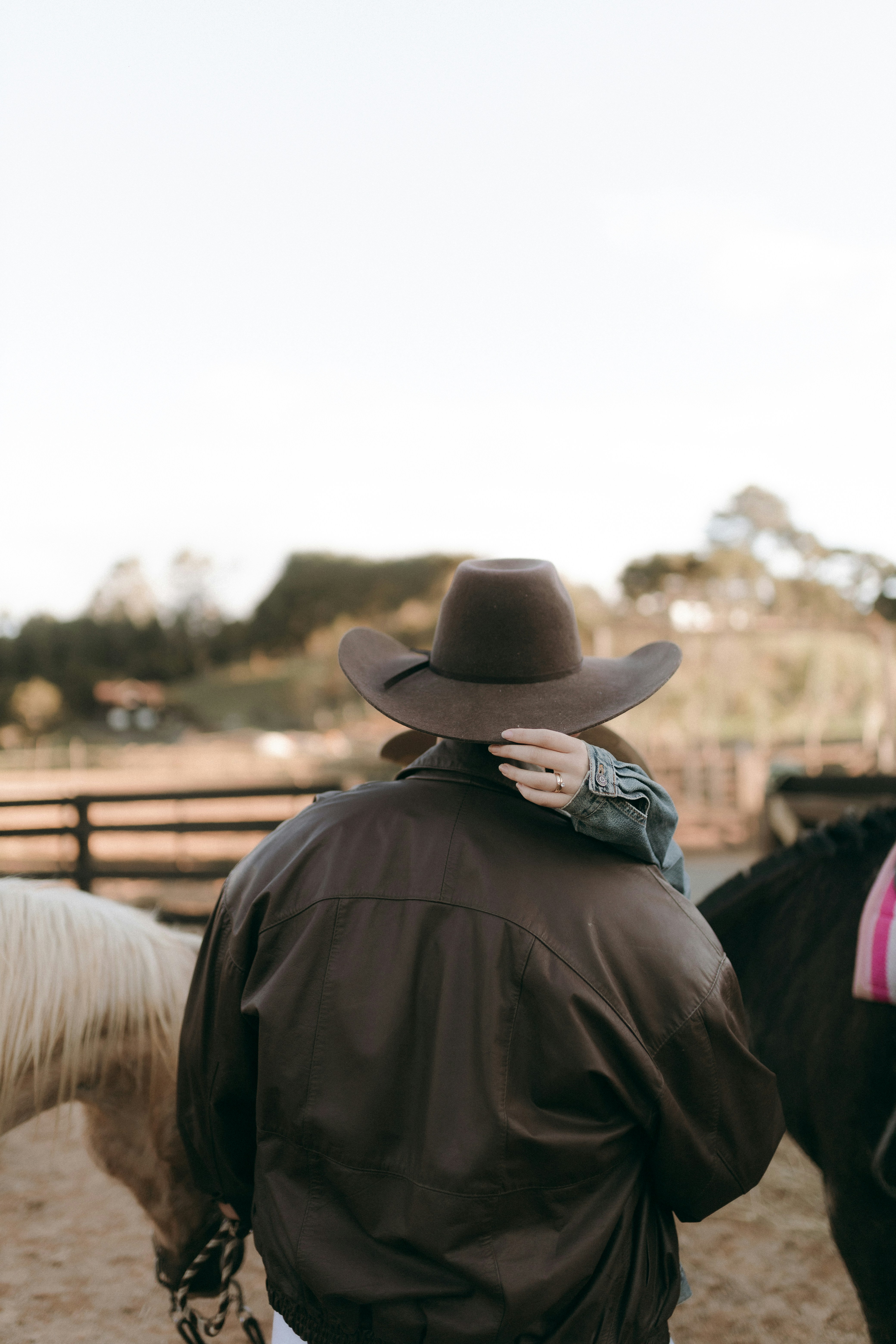 Cowboy and woman with horses on ranch