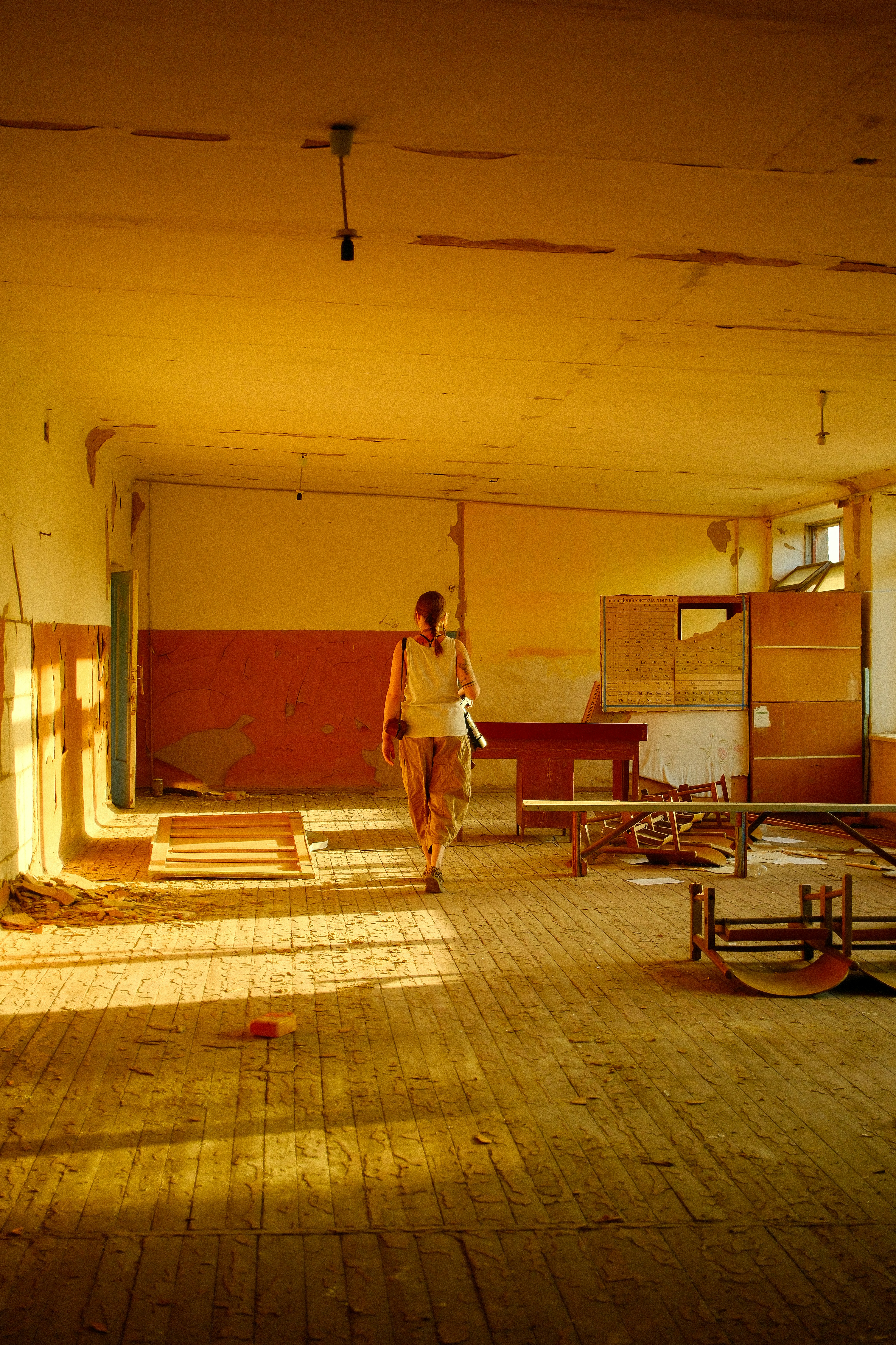 Woman walking through an abandoned room