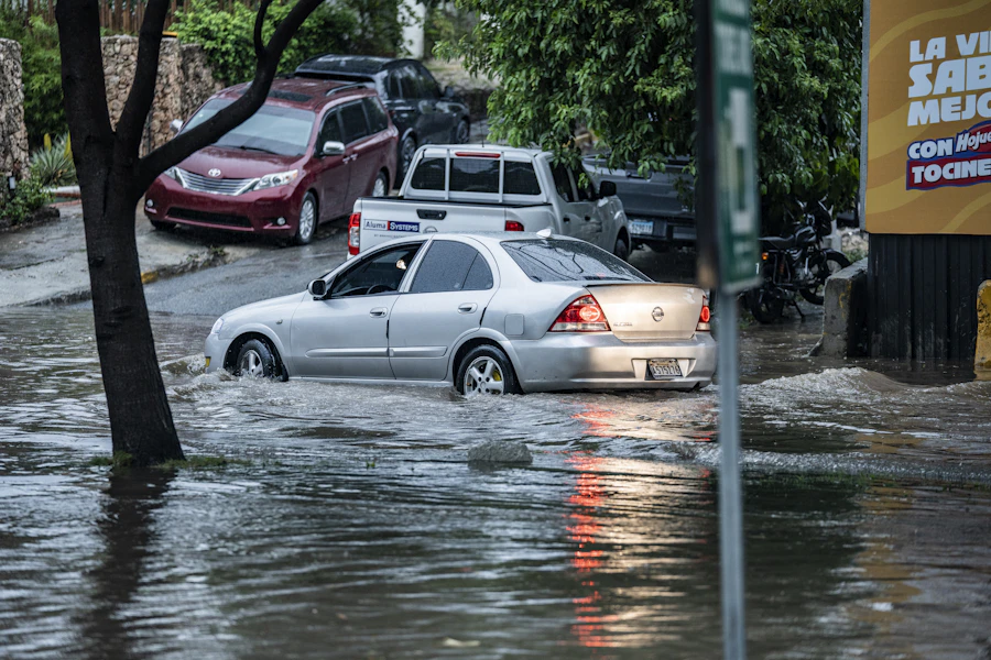 Cars driving through a flooded street after heavy rain