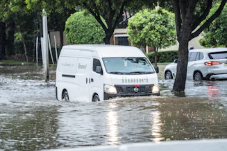 White van driving through flooded street